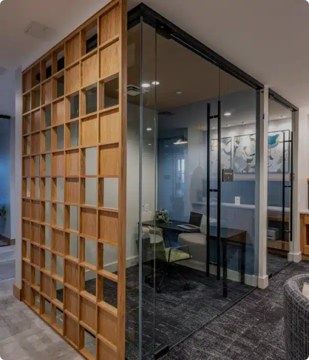 Modern glass-walled office room with wooden grid divider and contemporary interior design